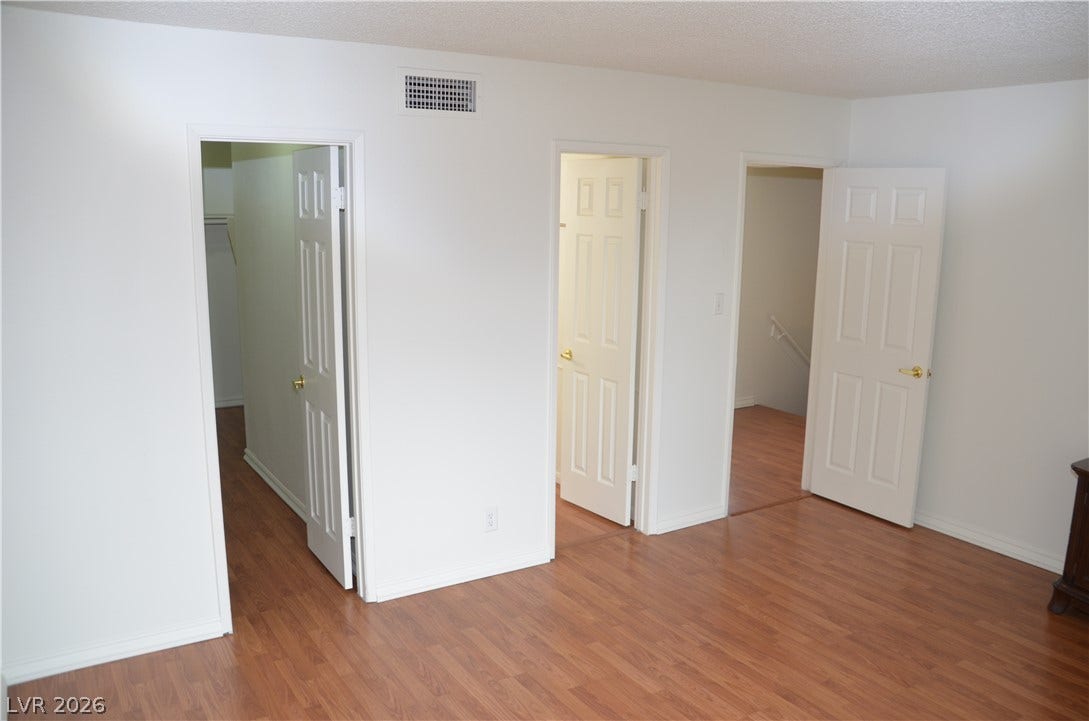 773 Cathy Lane, Henderson, NV 89015 Rich wood-toned flooring coordinates beautifully with neutral walls and multiple panel doors.