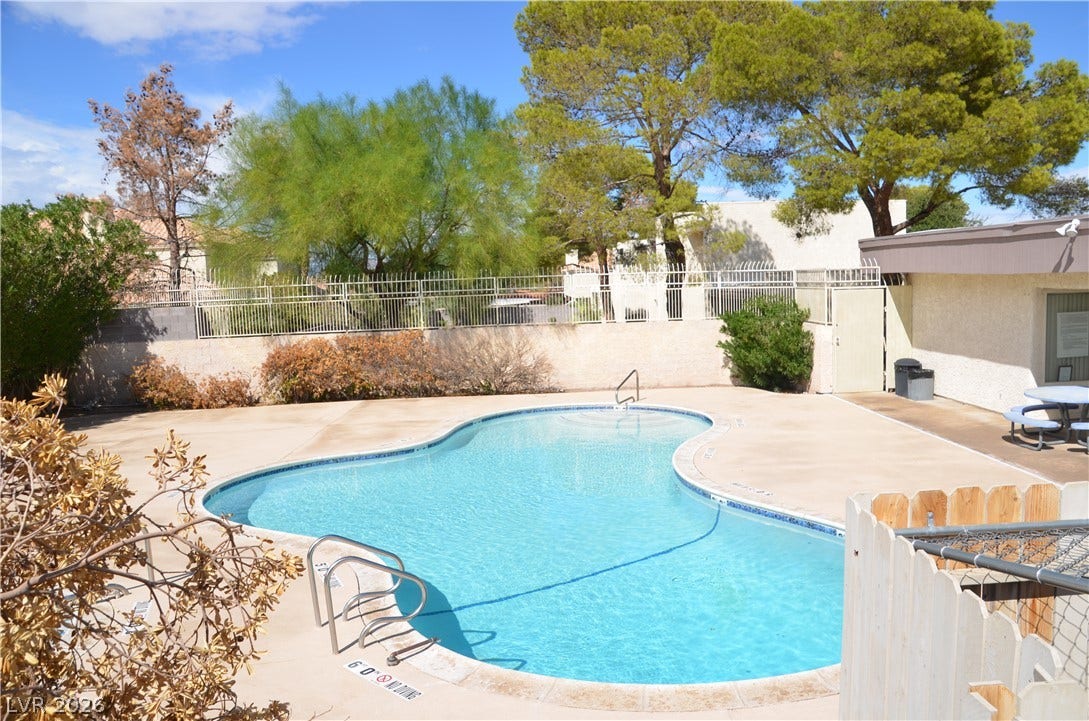 773 Cathy Lane, Henderson, NV 89015 Mature trees frame a private swimming pool surrounded by a spacious concrete patio.