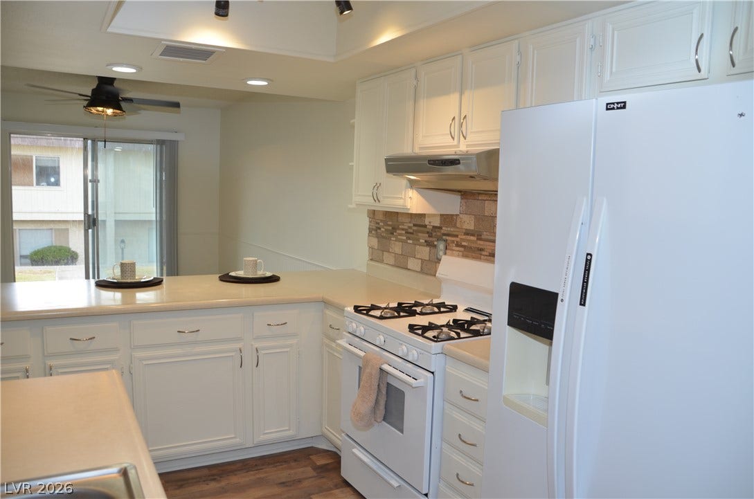 773 Cathy Lane, Henderson, NV 89015 Functional kitchen design integrates white cabinetry with an open breakfast bar layout.