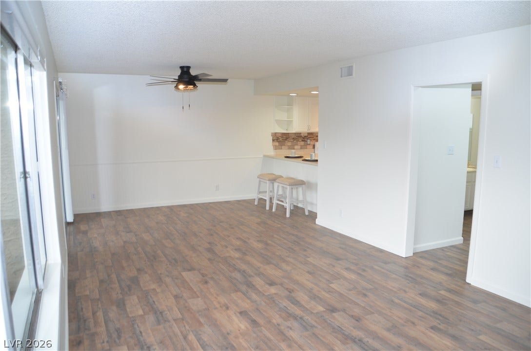 773 Cathy Lane, Henderson, NV 89015 Rich wood-inspired flooring anchors this open living space adjacent to a convenient breakfast bar.