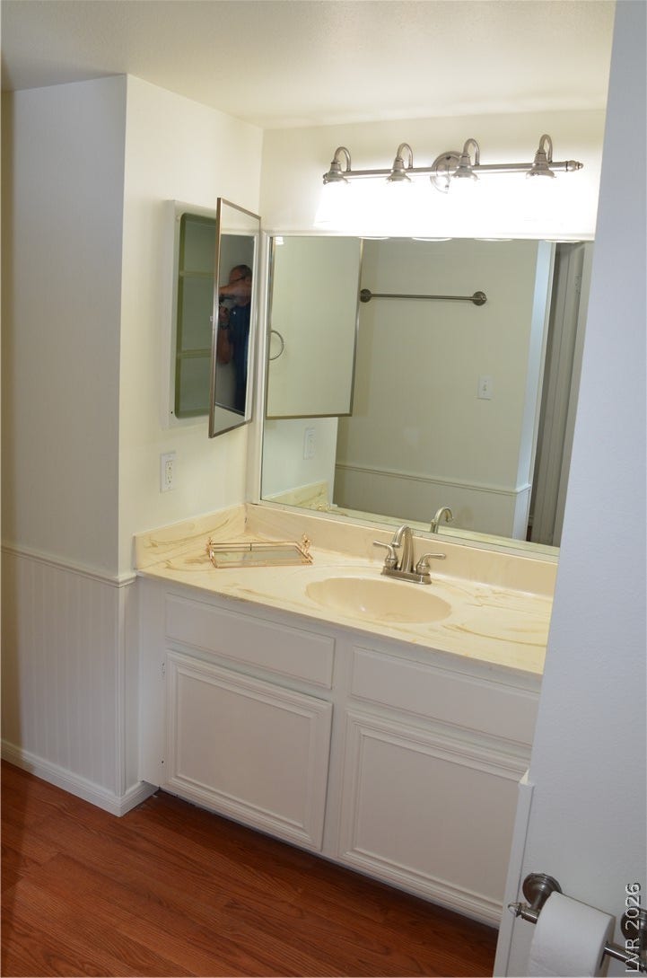773 Cathy Lane, Henderson, NV 89015 Gleaming wood floors anchor a well-appointed vanity area featuring wainscoting and integrated lighting.