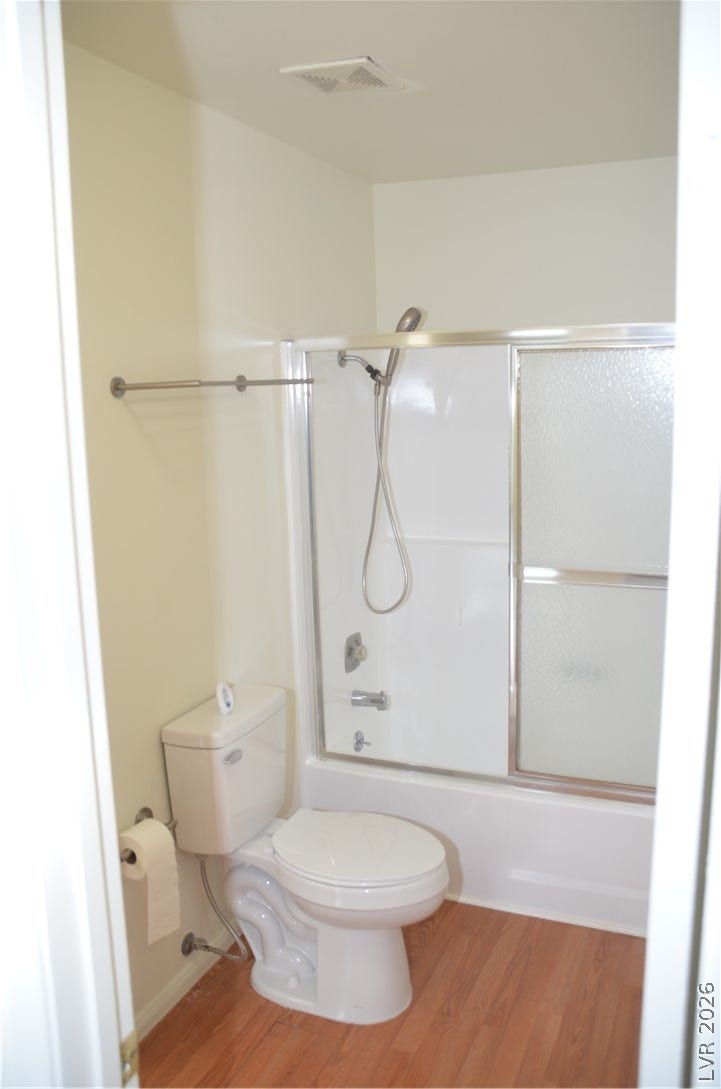773 Cathy Lane, Henderson, NV 89015 A classic tub and shower combination anchors this space alongside warm wood-look flooring.
