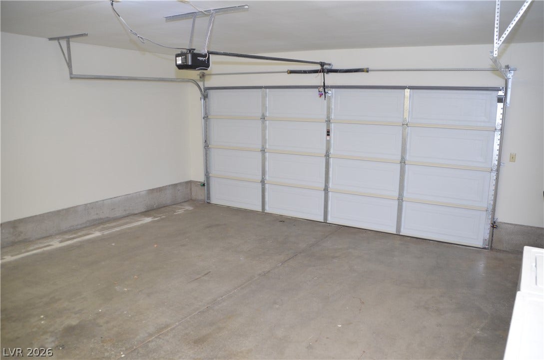 773 Cathy Lane, Henderson, NV 89015 A spacious garage features durable concrete flooring and an automatic overhead door opener.