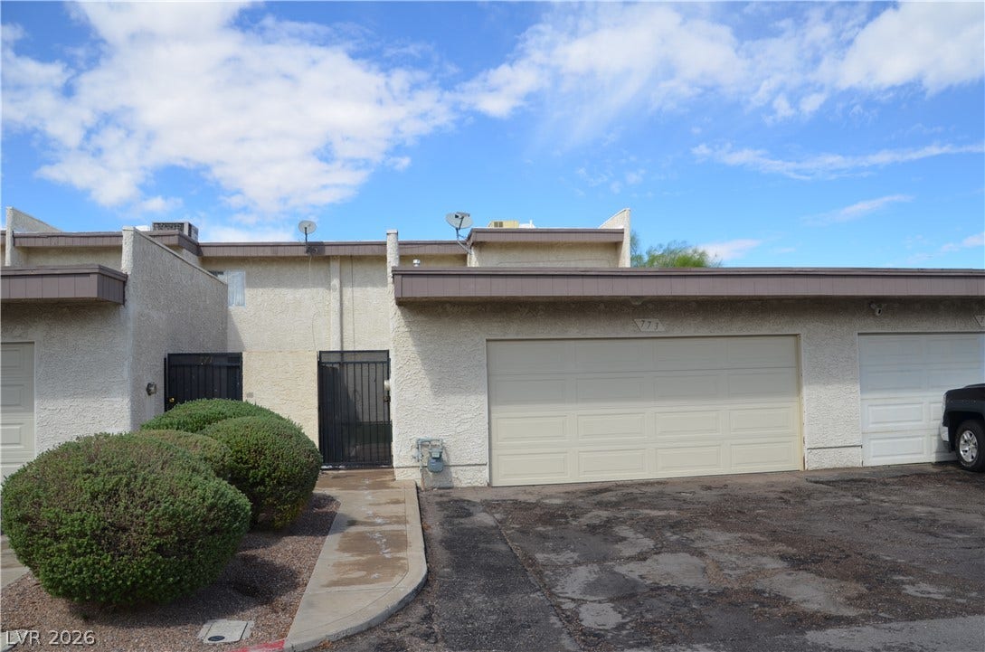 773 Cathy Lane, Henderson, NV 89015 Stucco exterior and an attached garage define this modern townhome facade.