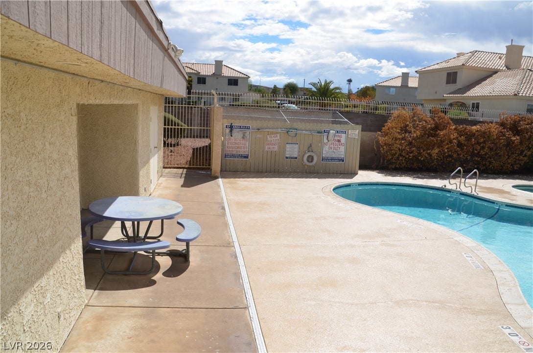 773 Cathy Lane, Henderson, NV 89015 A curved inground pool sits adjacent to a concrete patio area.