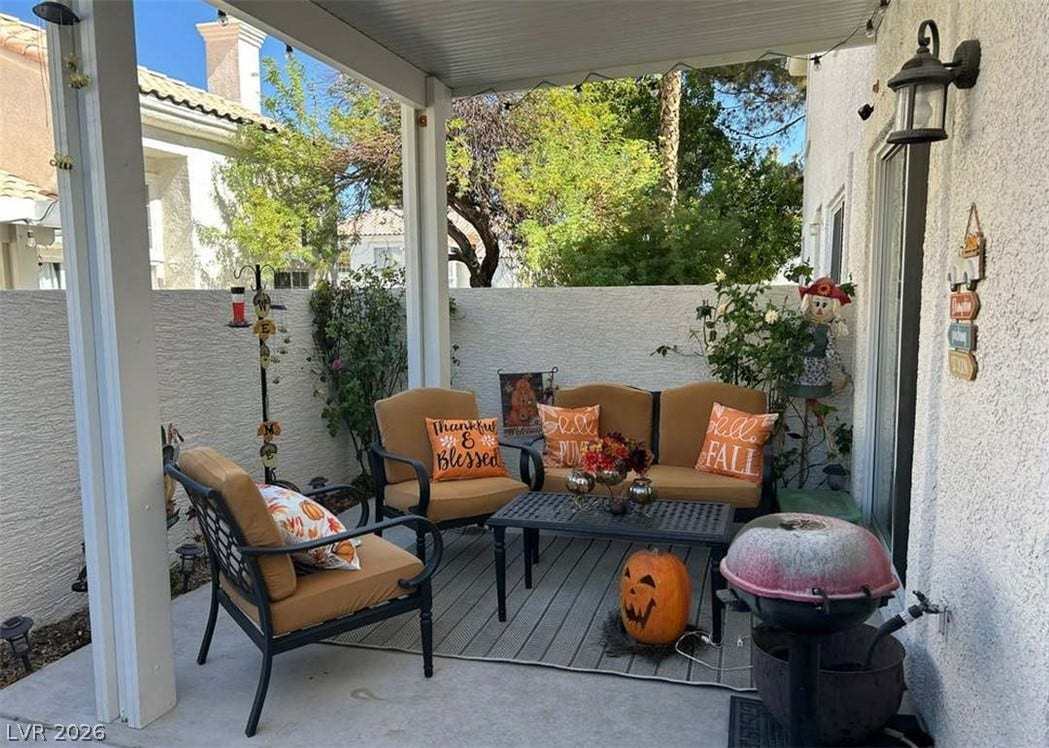 Shaded concrete patio area ideal for outdoor relaxation and quiet neighborhood views.