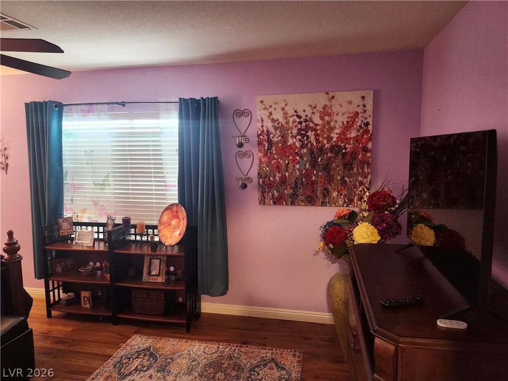 Gleaming hardwood floors and a wide window frame this cozy living space.