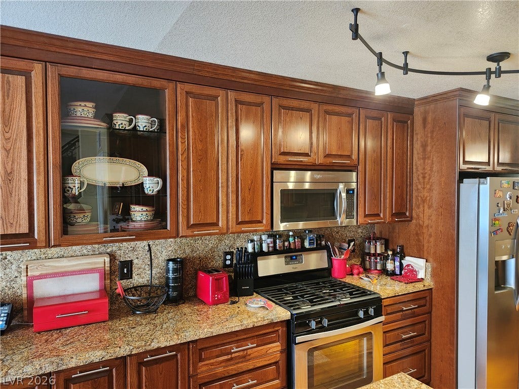 Rich wood cabinetry pairs beautifully with granite countertops in this functional workspace.