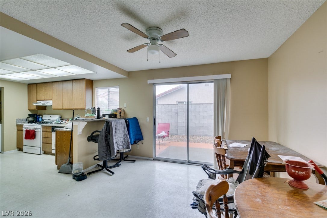Sliding glass doors open from the dining area directly onto the private backyard patio.