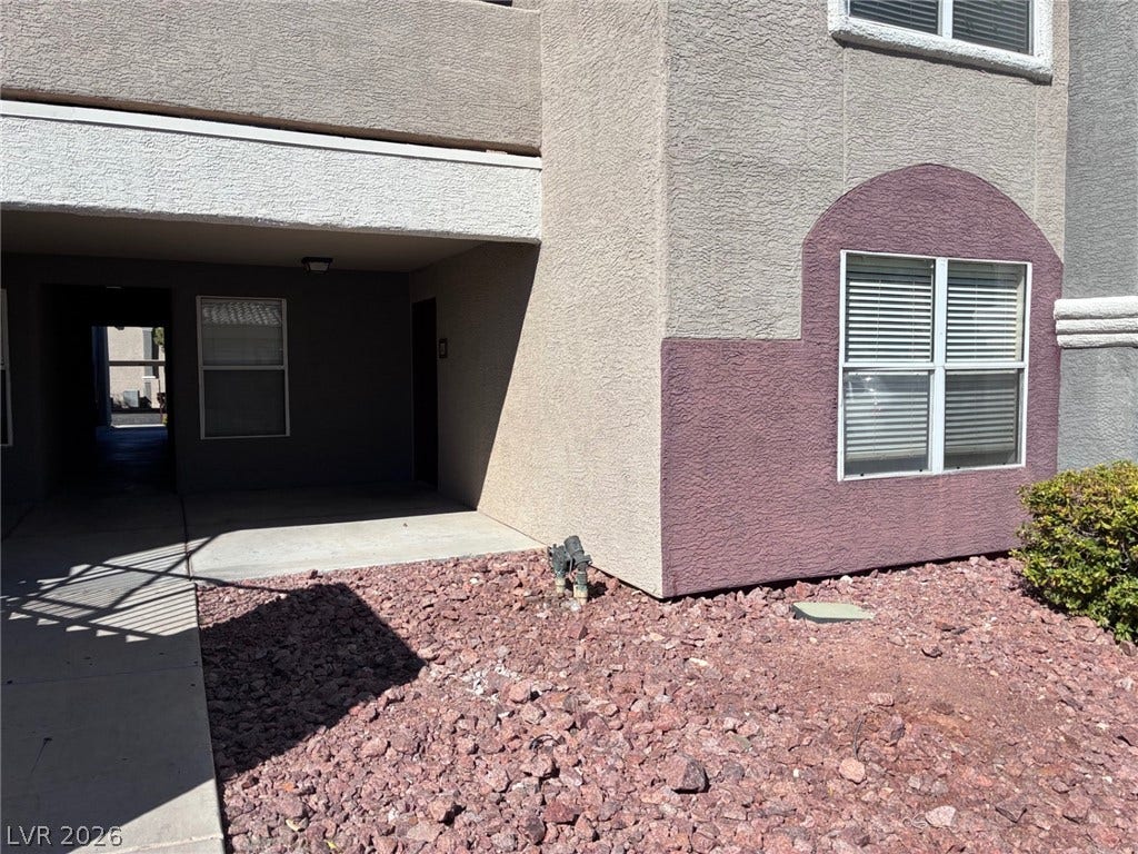 5055 W Hacienda Avenue, #1062, Las Vegas, NV 89118 Stucco exterior finishes and large windows define this multi-level residential entry.