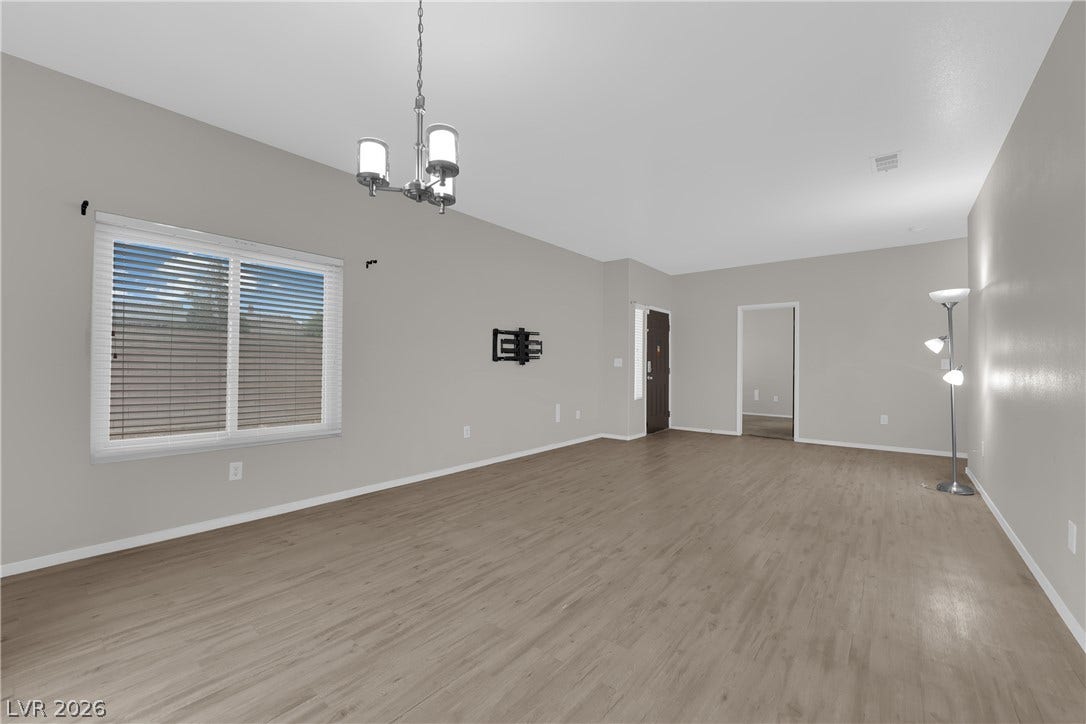 2653 Thunder Struck Court, North Las Vegas, NV 89030 Smooth wood-look flooring and a classic chandelier define this open living space.