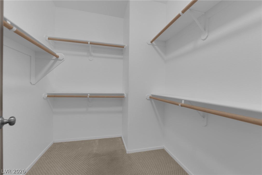 2653 Thunder Struck Court, North Las Vegas, NV 89030 Ample built-in shelving and hanging rods maximize storage within this carpeted walk-in closet.