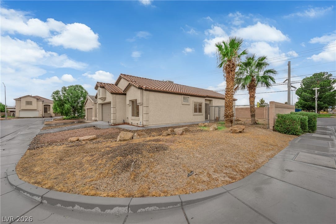 2653 Thunder Struck Court, North Las Vegas, NV 89030 Palm trees frame the stucco exterior and tiled roofline of this corner lot home.