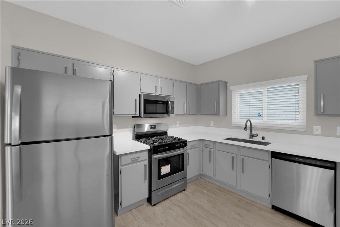 2653 Thunder Struck Court, North Las Vegas, NV 89030 Streamlined cabinetry and contemporary solid-surface countertops define this updated kitchen workspace.