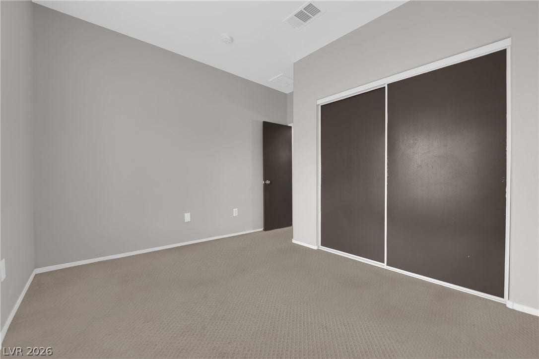 2653 Thunder Struck Court, North Las Vegas, NV 89030 Plush carpeting and integrated closet storage anchor this versatile room.