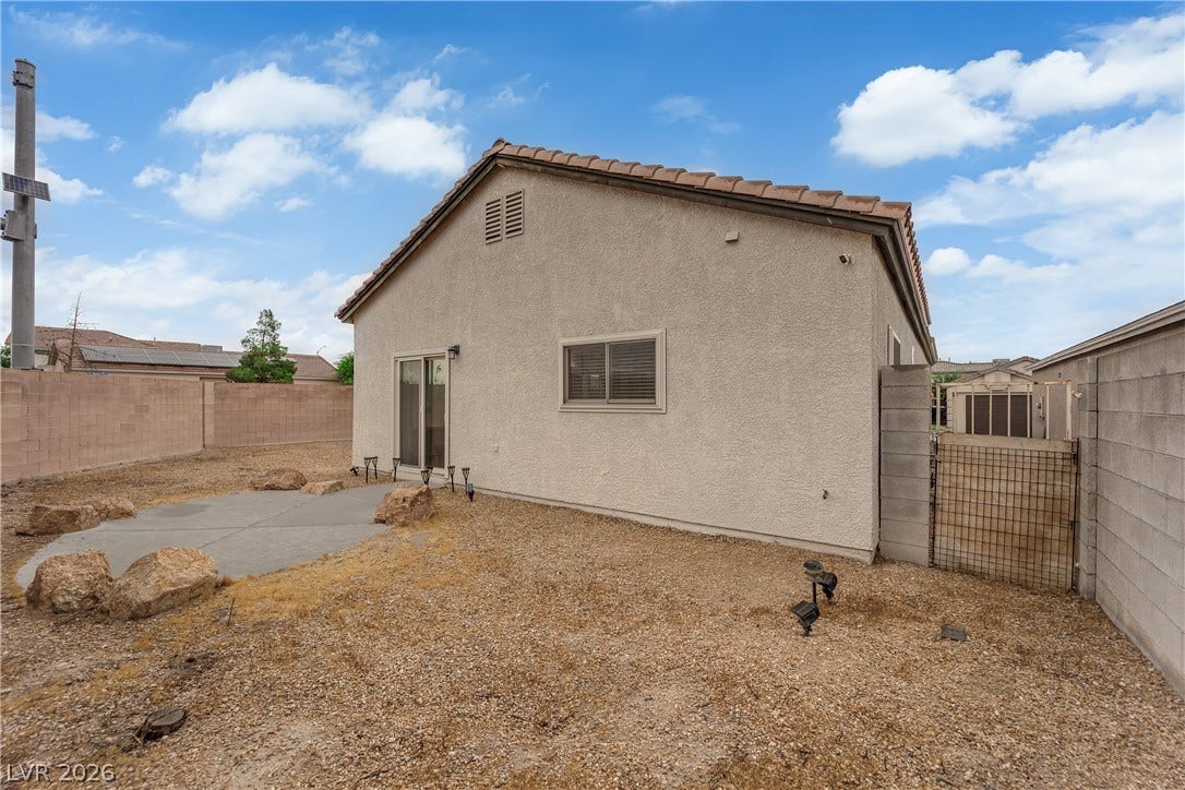 2653 Thunder Struck Court, North Las Vegas, NV 89030 Enclosed block fencing surrounds a low-maintenance gravel yard with a small concrete patio.