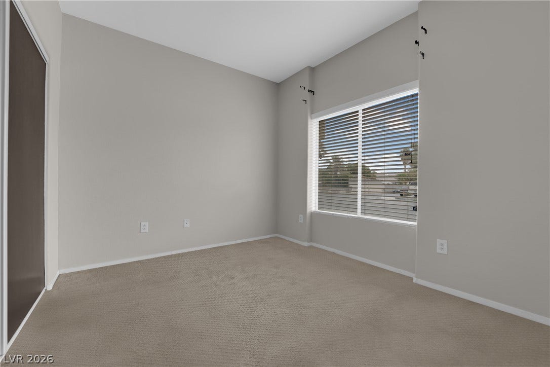 2653 Thunder Struck Court, North Las Vegas, NV 89030 High vaulted ceilings and neutral carpeting define this airy bedroom space with a large window.