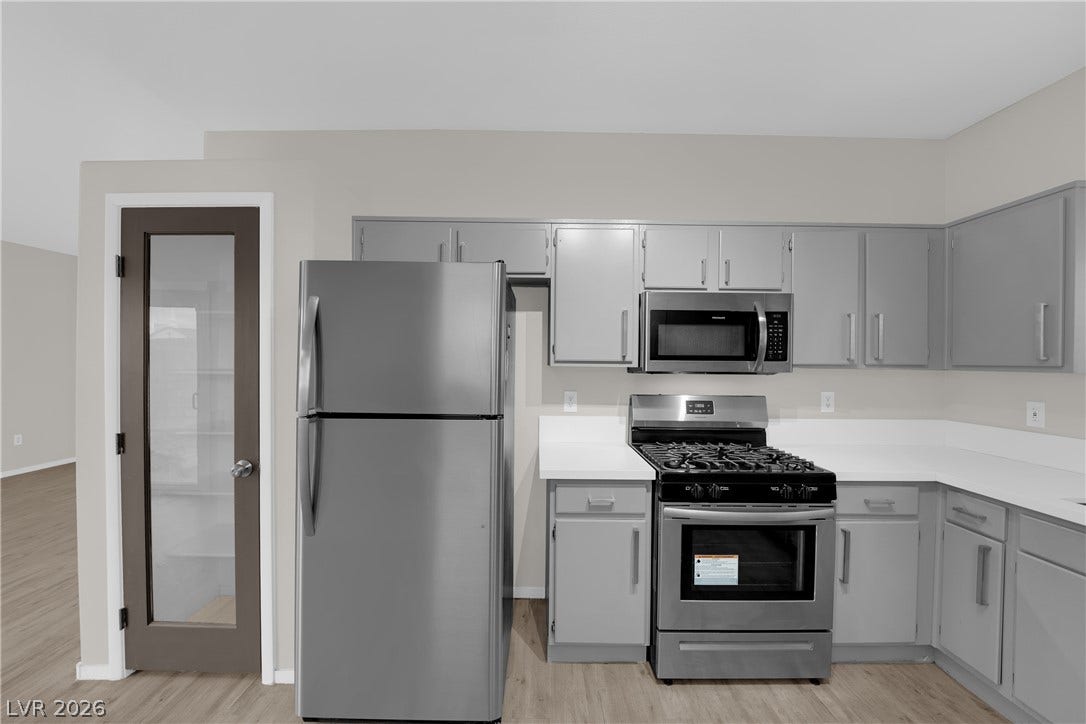 2653 Thunder Struck Court, North Las Vegas, NV 89030 Sleek solid countertops complement the modern cabinetry and stainless steel appliances in this kitchen.