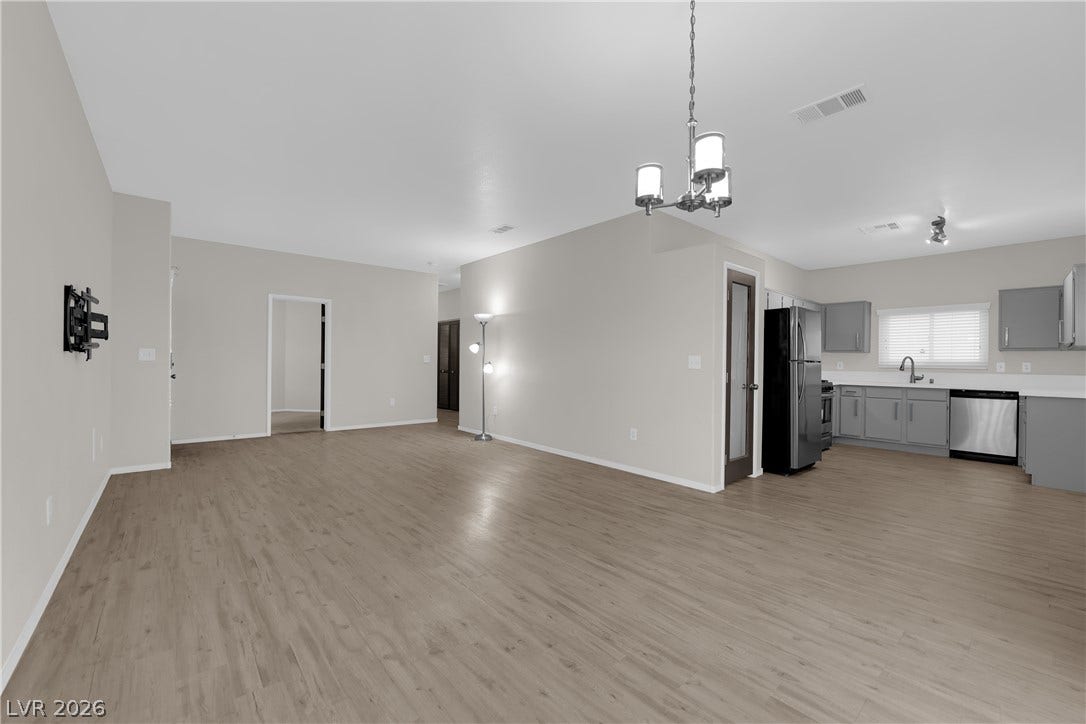 2653 Thunder Struck Court, North Las Vegas, NV 89030 Gleaming wood-look floors anchor this airy, open-concept living area and adjacent kitchen.