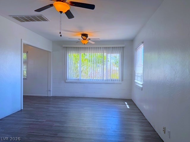 107 Joshua Street, Henderson, NV 89015 Smooth wood floors anchor this open living area framed by generous windows.