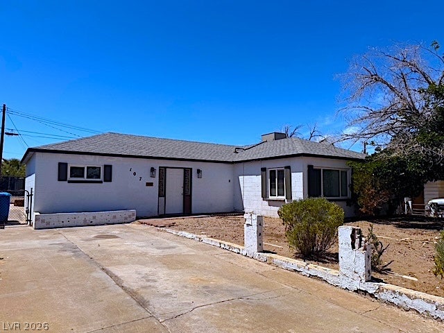 107 Joshua Street, Henderson, NV 89015 Classic single-story architecture is defined by a low-profile silhouette and a wide concrete driveway.