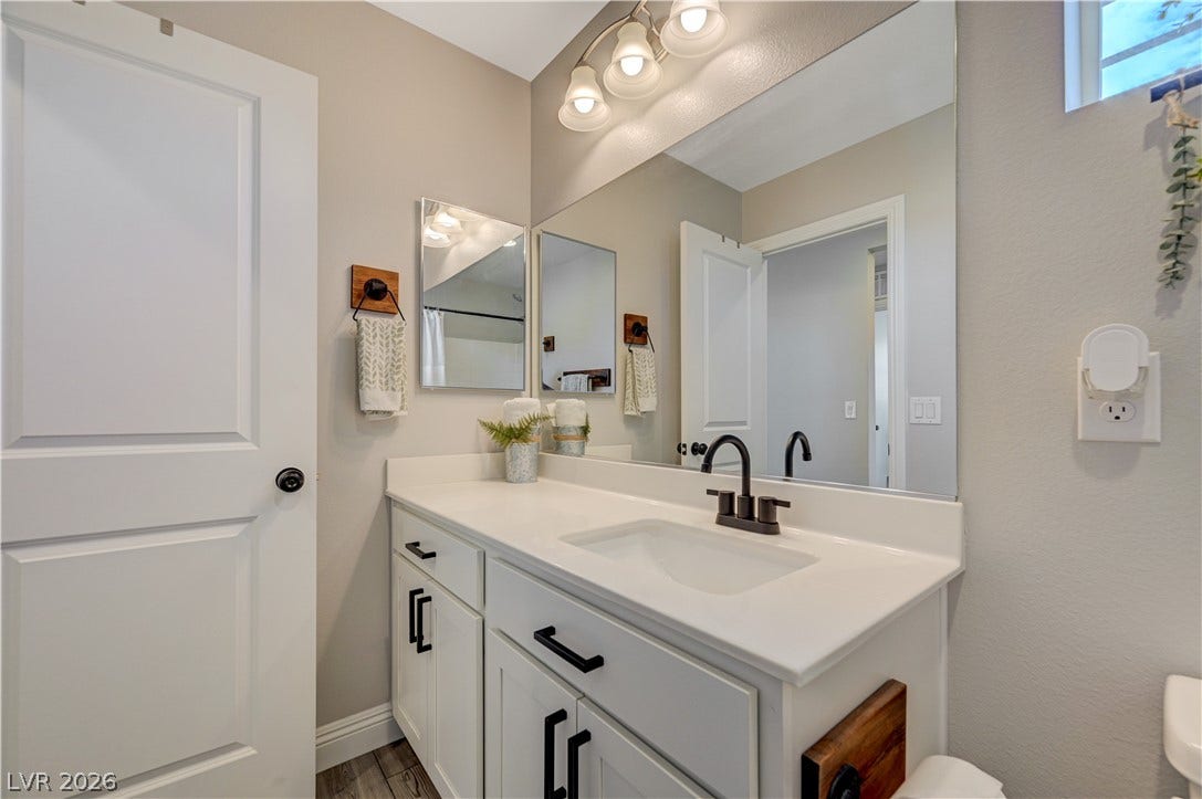 6629 Rockhouse Street, North Las Vegas, NV 89086 Modern cabinetry and clean countertops define this sleek bath space.