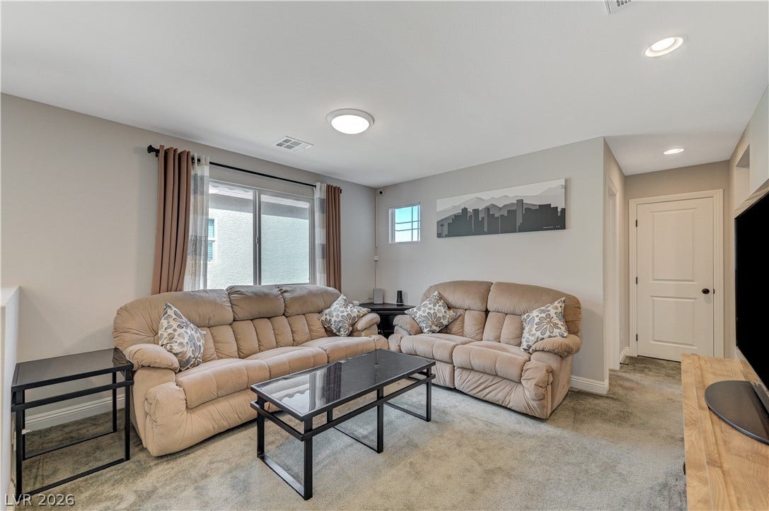 6629 Rockhouse Street, North Las Vegas, NV 89086 Recessed lighting and soft carpet floor finish this comfortable living area.