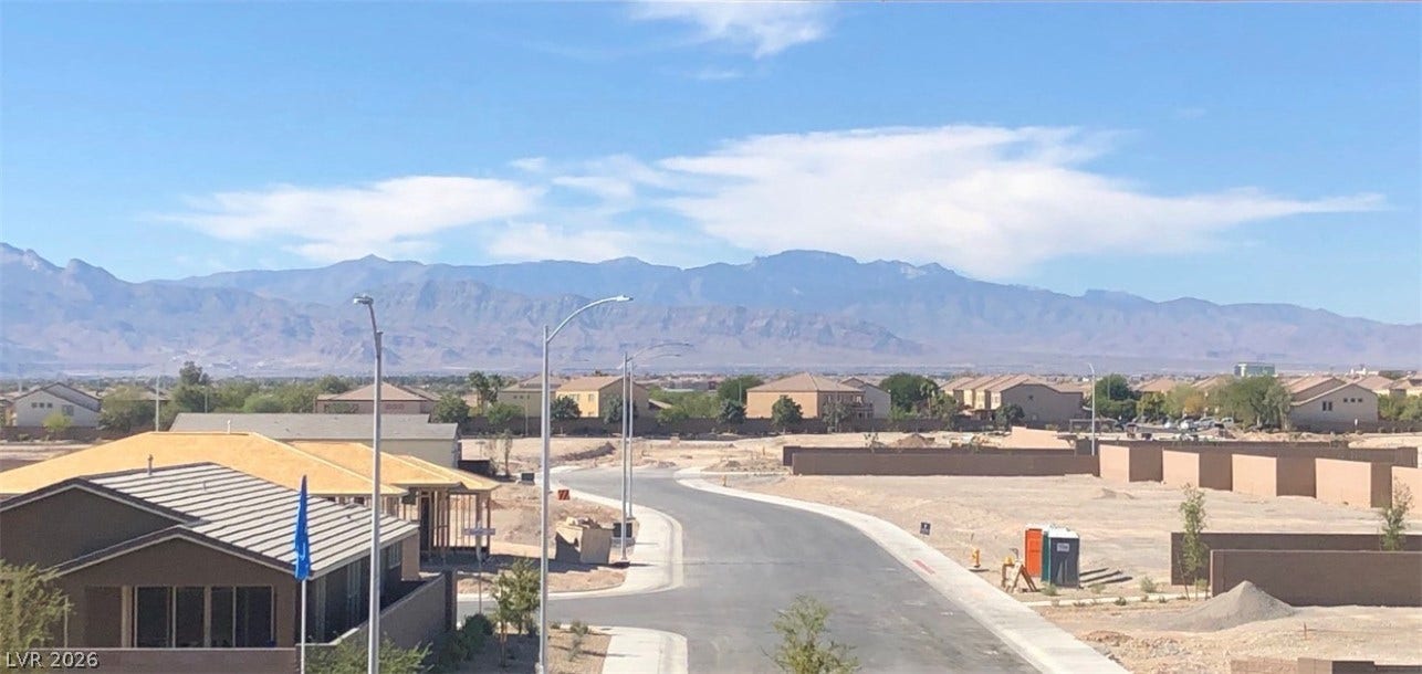 6629 Rockhouse Street, North Las Vegas, NV 89086 Panoramic mountain ridges create a scenic background beyond the developing neighborhood.