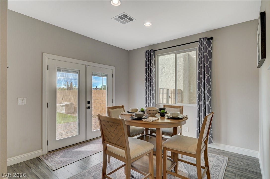 6629 Rockhouse Street, North Las Vegas, NV 89086 Double doors open to the outdoors from a dining area featuring wood flooring.