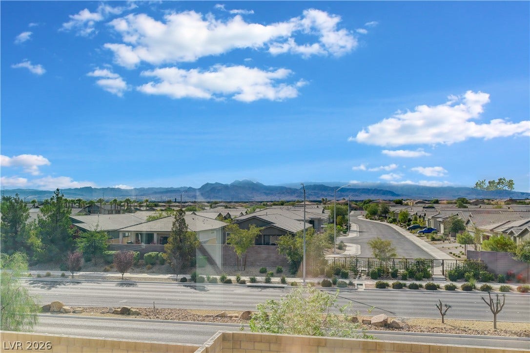 6629 Rockhouse Street, North Las Vegas, NV 89086 Vast mountain skylines and quiet neighborhood streets stretch beneath a brilliant desert sky.