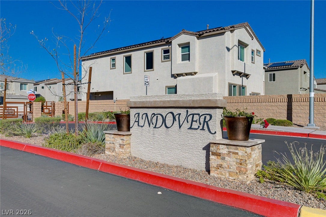 6629 Rockhouse Street, North Las Vegas, NV 89086 A stucco monument sign marks the entry to this modern residential community.