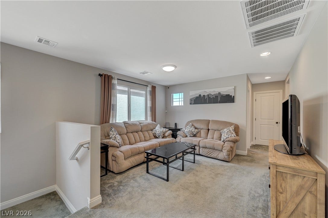 6629 Rockhouse Street, North Las Vegas, NV 89086 A spacious carpeted upper-level living area offers comfortable proportions and neutral wall finishes.