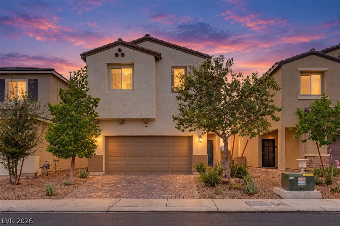 6629 Rockhouse Street, North Las Vegas, NV 89086 An inviting exterior features a paved driveway leading to a two-story stucco residence.