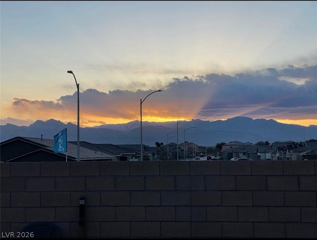 6629 Rockhouse Street, North Las Vegas, NV 89086 Dramatic mountain horizons framing the surrounding residential landscape during sunset.