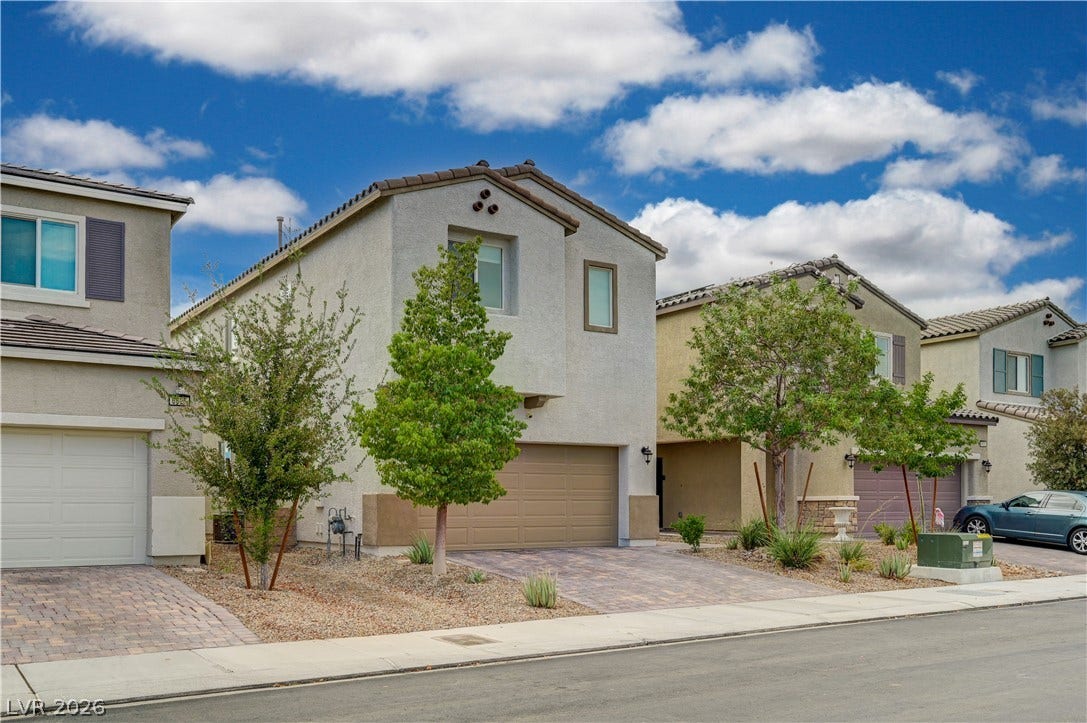 6629 Rockhouse Street, North Las Vegas, NV 89086 Clean lines and a paved driveway define this contemporary two-story home with desert landscaping.
