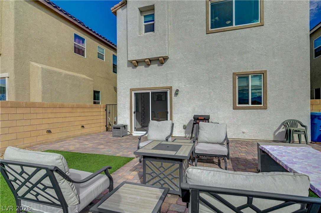 6629 Rockhouse Street, North Las Vegas, NV 89086 An inviting paved patio area sits adjacent to the stucco exterior of this residence.
