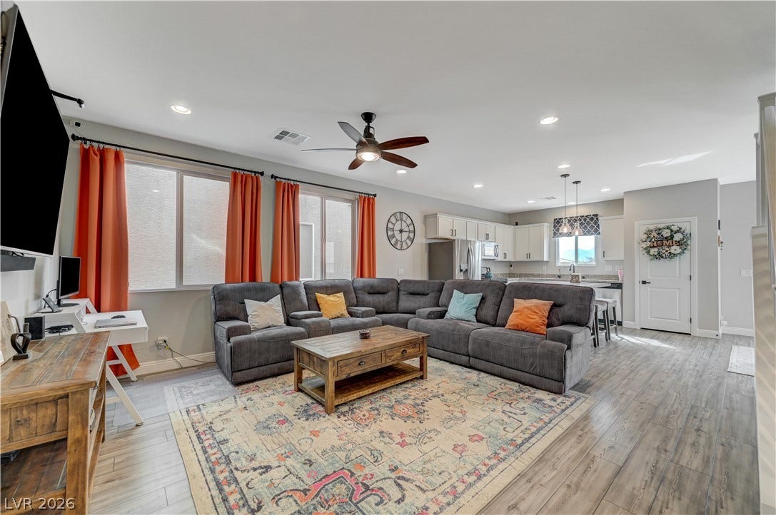6629 Rockhouse Street, North Las Vegas, NV 89086 An open-concept living area flows seamlessly into the kitchen over durable wood-look flooring.