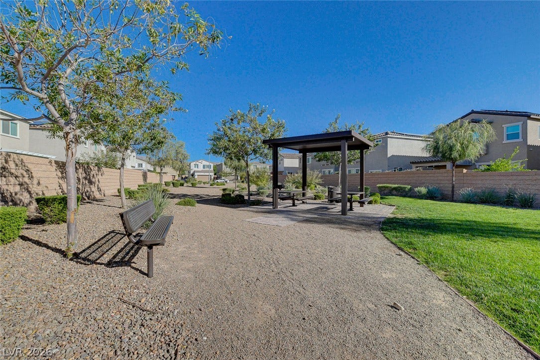 6629 Rockhouse Street, North Las Vegas, NV 89086 A community park area features a shaded picnic pavilion alongside gravel pathways and manicured lawns.