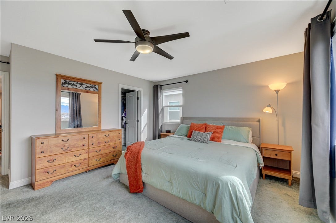 6629 Rockhouse Street, North Las Vegas, NV 89086 Soft carpeting underfoot and an attached walk-in closet highlight this peaceful bedroom space.