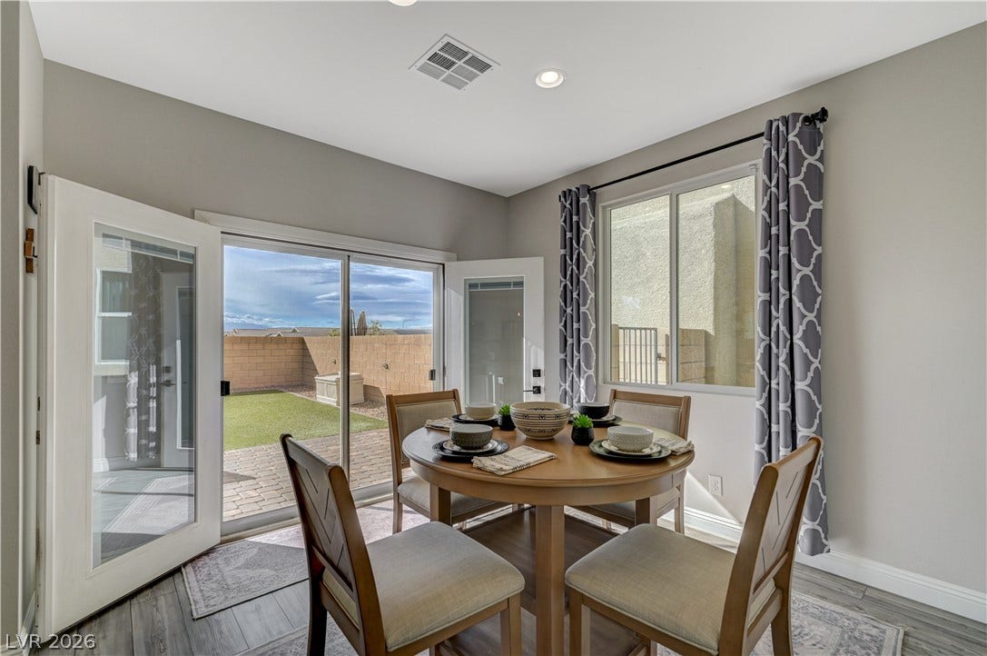 6629 Rockhouse Street, North Las Vegas, NV 89086 Sunlight streams through large windows and sliding glass doors into this casual dining area.