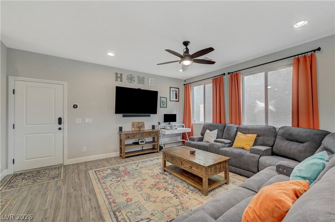 6629 Rockhouse Street, North Las Vegas, NV 89086 Gleaming wood-look floors anchor this welcoming living area illuminated by recessed lighting.