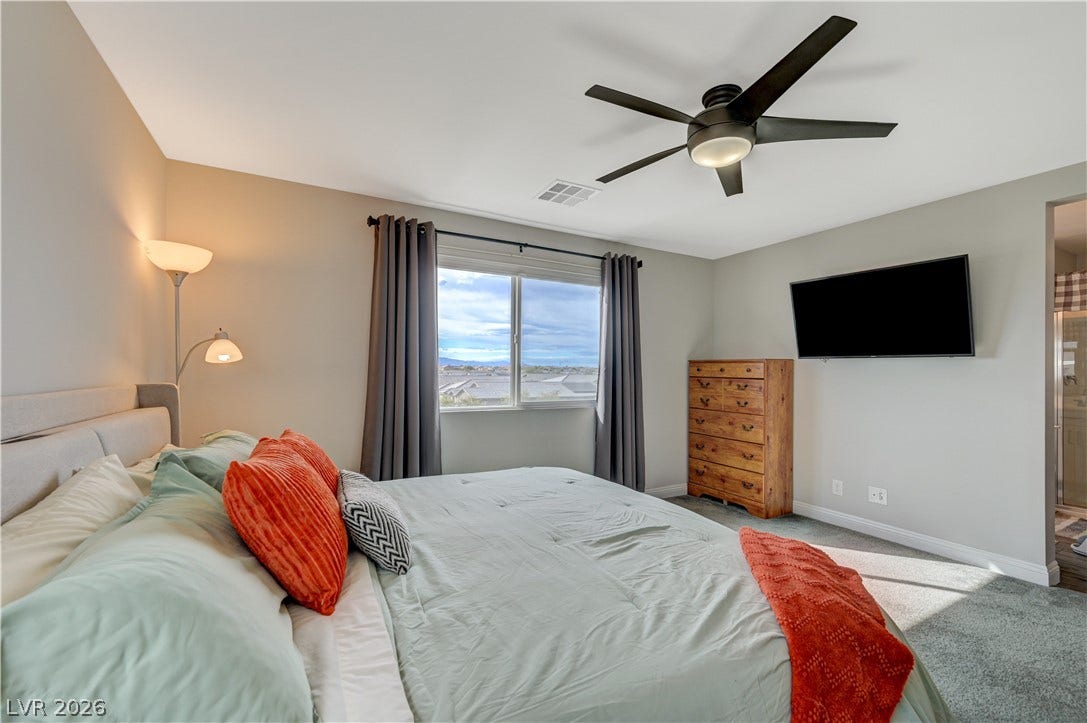 6629 Rockhouse Street, North Las Vegas, NV 89086 Plush carpet and a large window framing neighborhood views create a relaxing atmosphere.
