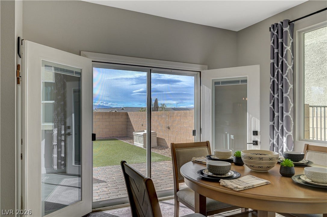 6629 Rockhouse Street, North Las Vegas, NV 89086 Double doors open to a paved patio and private yard area.