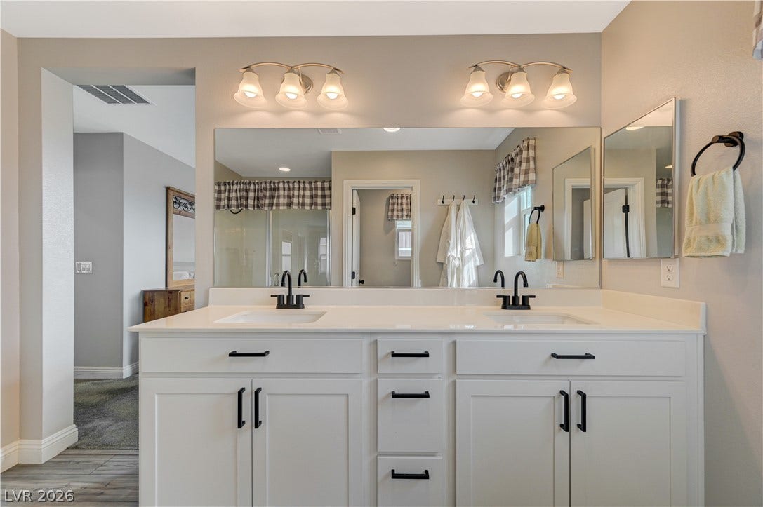 6629 Rockhouse Street, North Las Vegas, NV 89086 Clean lines and a spacious dual vanity highlight this master bathroom design.