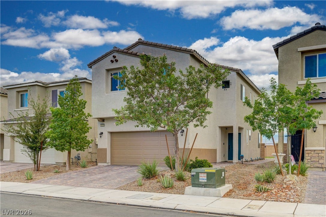 6629 Rockhouse Street, North Las Vegas, NV 89086 Contemporary two-story architecture features clean stucco finishes under a classic tile roof.