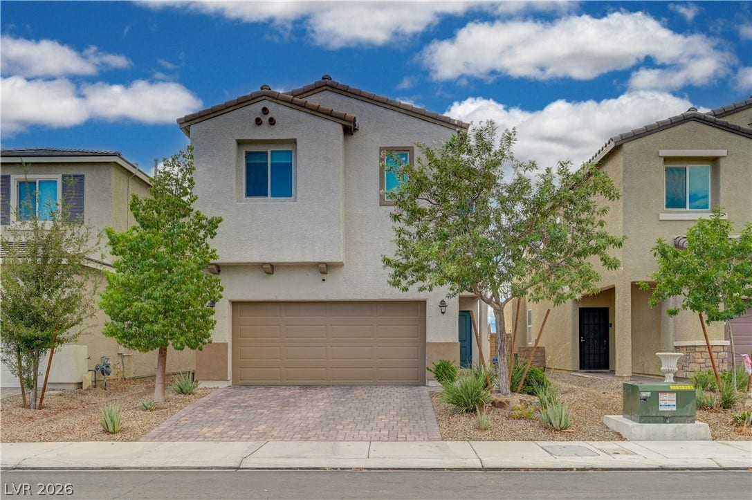 6629 Rockhouse Street, North Las Vegas, NV 89086 Mediterranean-inspired facade with clean stucco finishes and a handsome paved driveway.