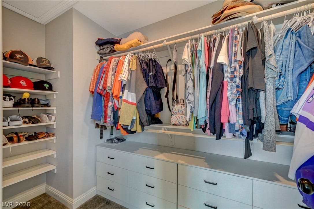 6629 Rockhouse Street, North Las Vegas, NV 89086 An organized walk-in closet boasts custom built-in drawers and ample hanging storage.