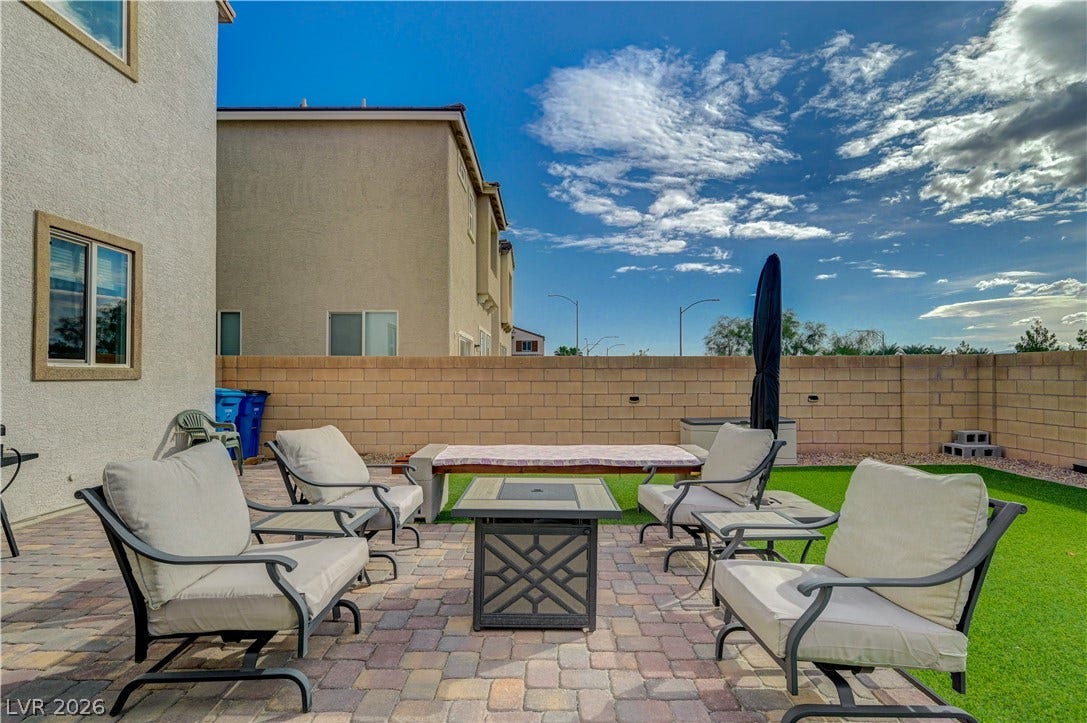 6629 Rockhouse Street, North Las Vegas, NV 89086 A paved patio and tidy lawn area sit enclosed by a private block wall.
