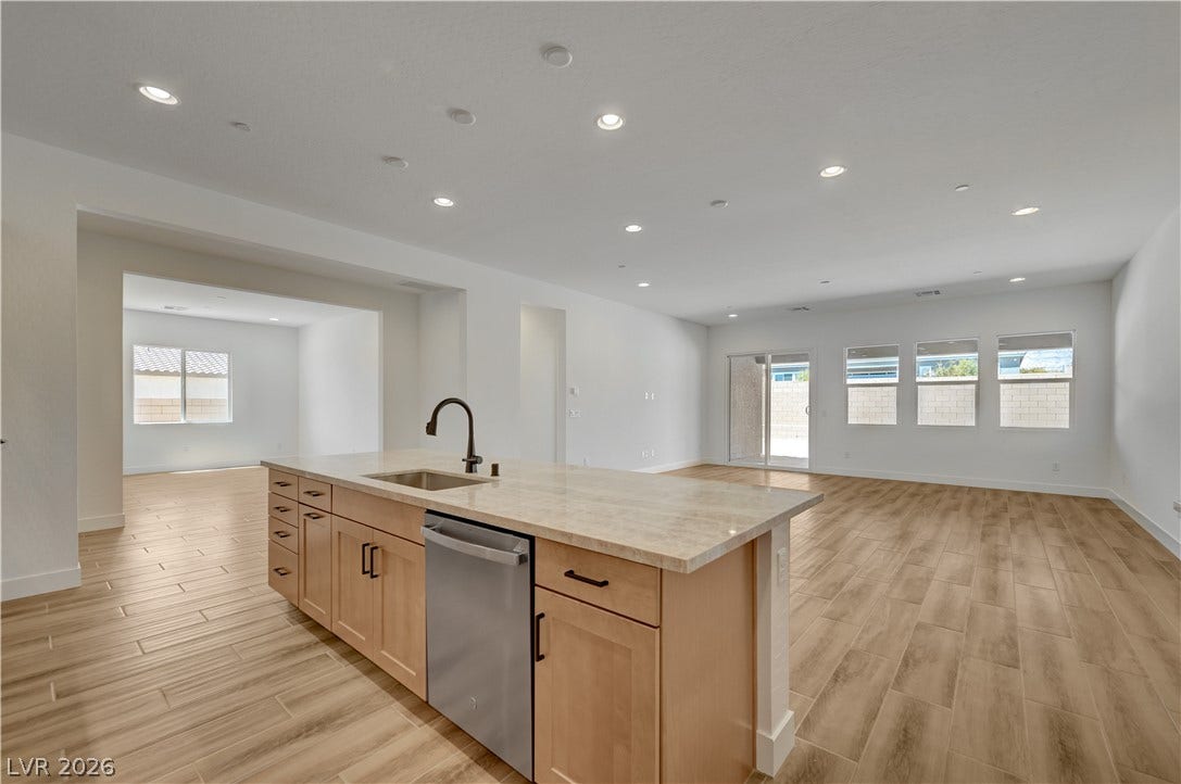 5689 Searching Bear Court, Las Vegas, NV 89149 A luminous open-concept living space boasts sleek wood-look tile flooring and abundant natural illumination.