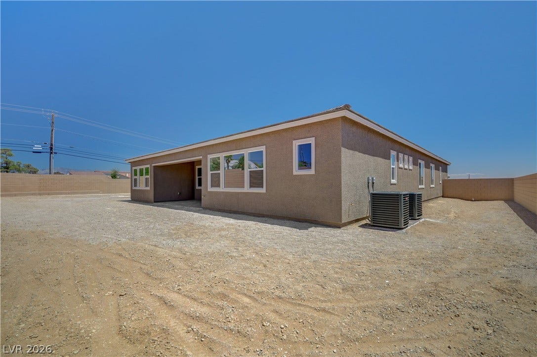 5689 Searching Bear Court, Las Vegas, NV 89149 A newly constructed, single-story residence stands under a clear sky, ready for landscaping.